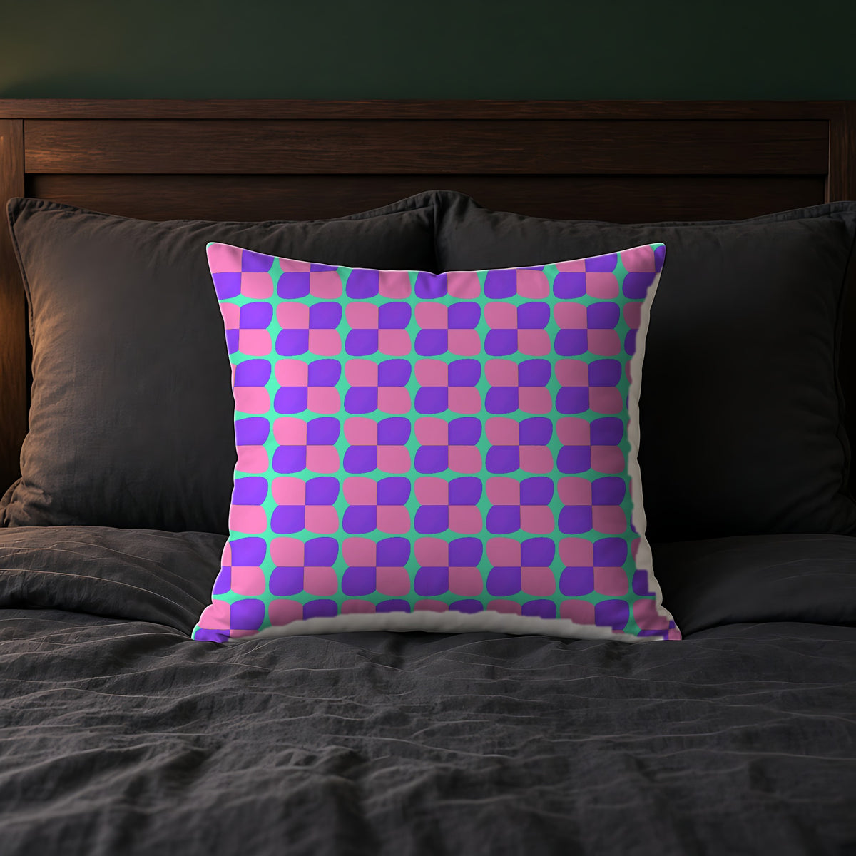 Bold Bulge Checker Faux Suede Cushion on a bed with charcoal bedding