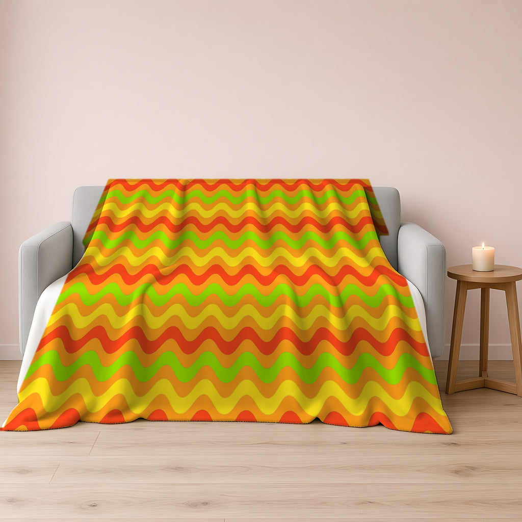 Big Ripple Chevrons Sherpa Fleece Blanket draped over a grey sofa
