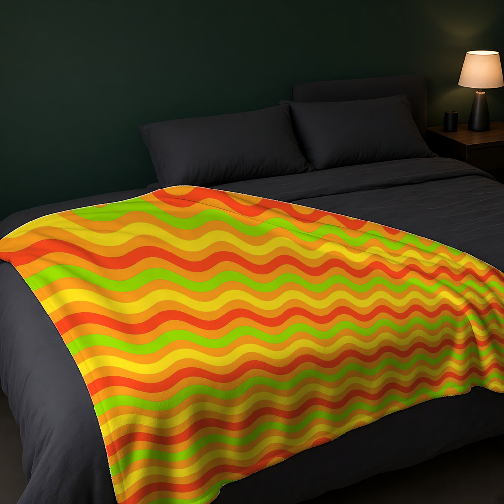 Big Ripple Chevrons Sherpa Fleece Blanket across the foot of a dark bed