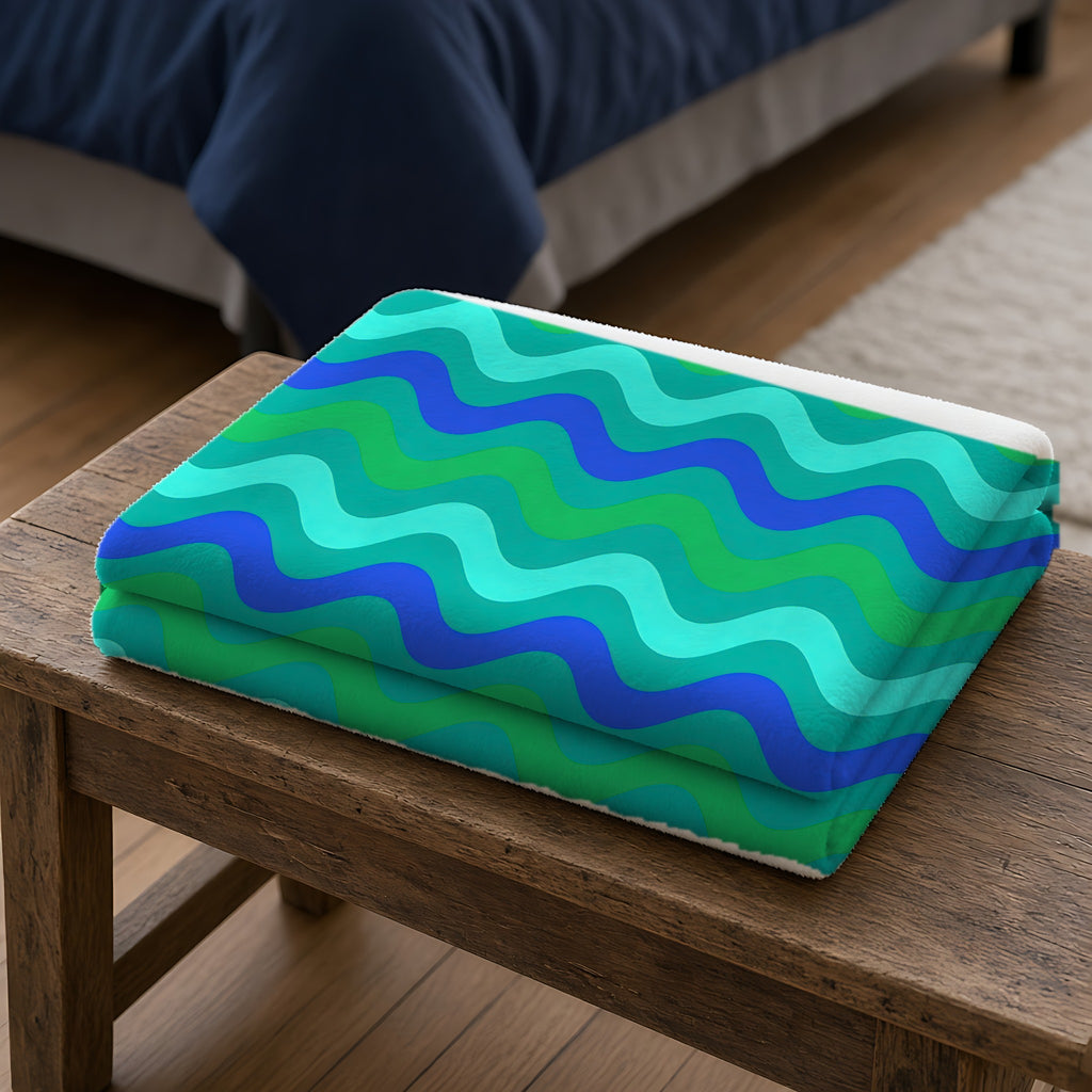 Big Ripple Chevrons Sherpa Fleece Blanket folded on a wooden bench