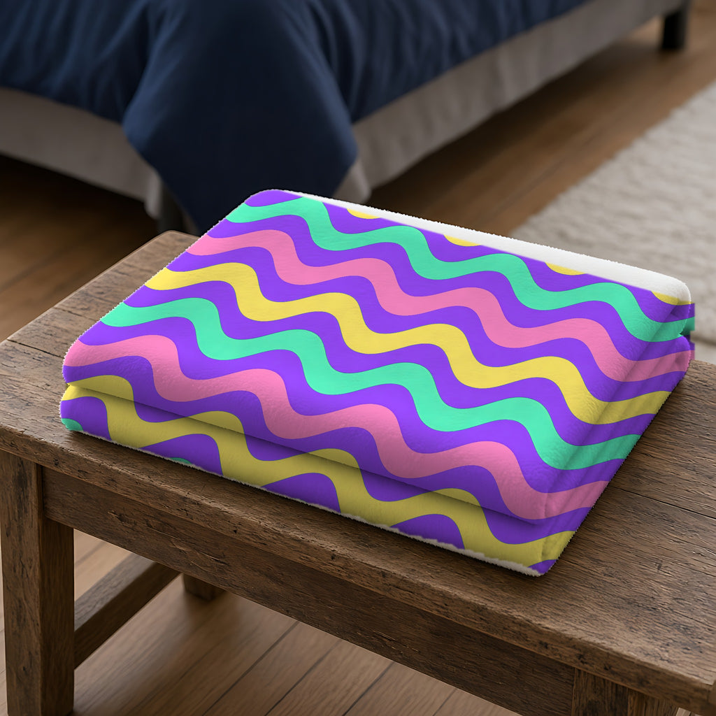 Big Ripple Chevrons Sherpa Fleece Blanket folded on a wooden bench