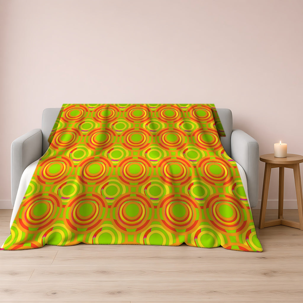 Interlocking Ring Ripples Sherpa Fleece Blanket draped over a grey sofa