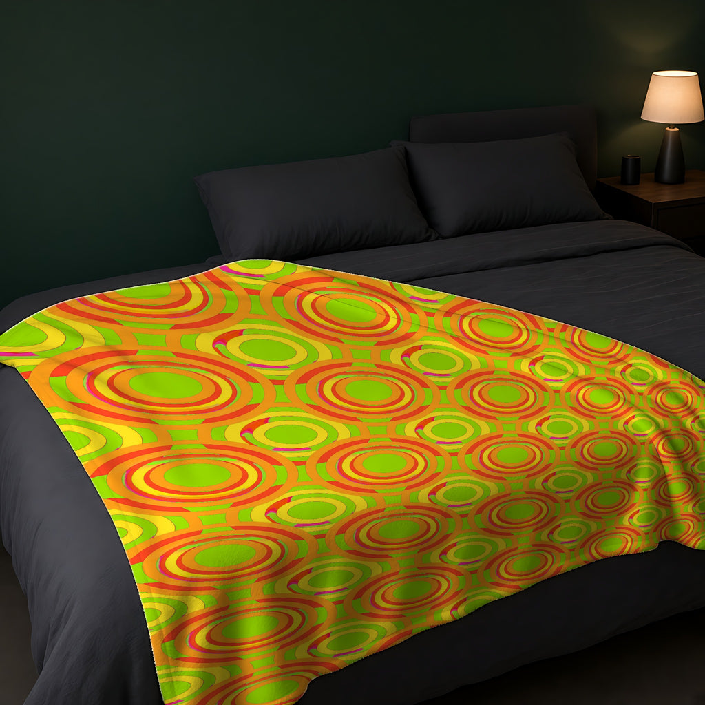 Interlocking Ring Ripples Sherpa Fleece Blanket across the foot of a dark bed