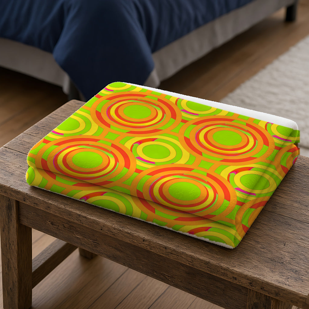 Interlocking Ring Ripples Sherpa Fleece Blanket folded on a wooden bench
