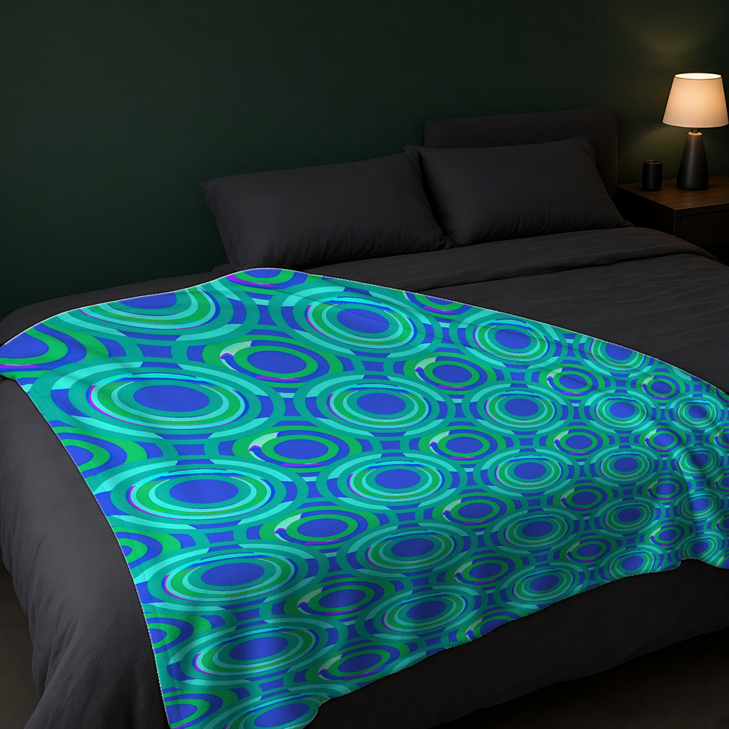 Interlocking Ring Ripples Sherpa Fleece Blanket across the foot of a dark bed