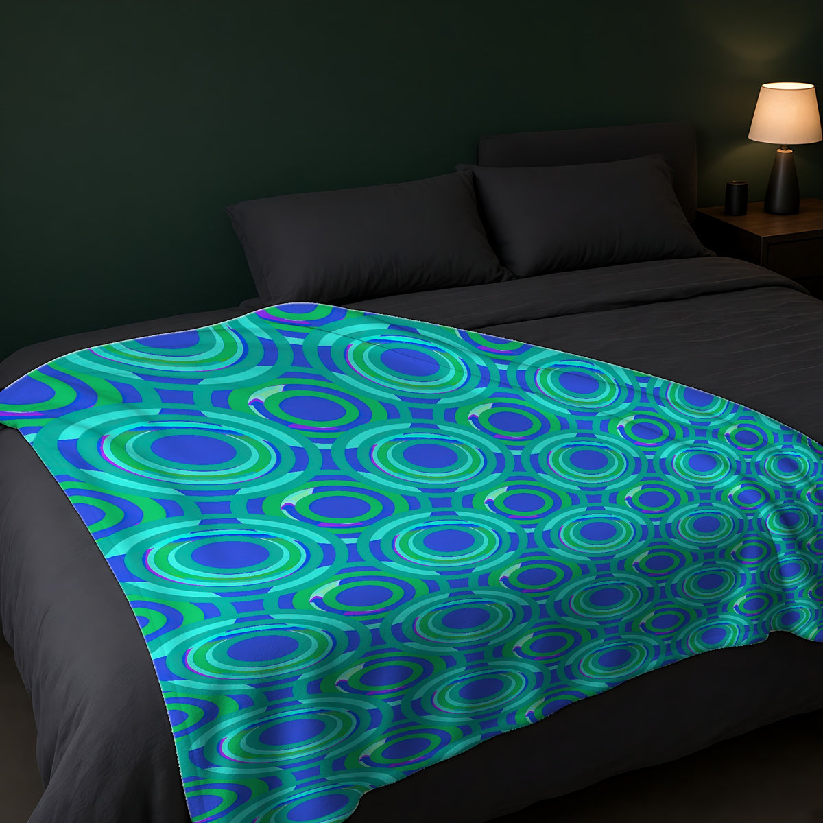 Interlocking Ring Ripples Sherpa Fleece Blanket across the foot of a dark bed