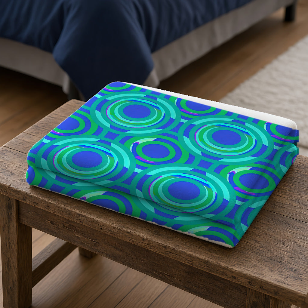 Interlocking Ring Ripples Sherpa Fleece Blanket folded on a wooden bench
