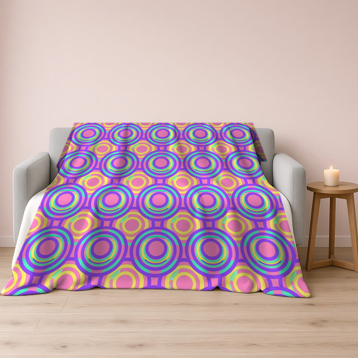 Interlocking Ring Ripples Sherpa Fleece Blanket draped over a grey sofa