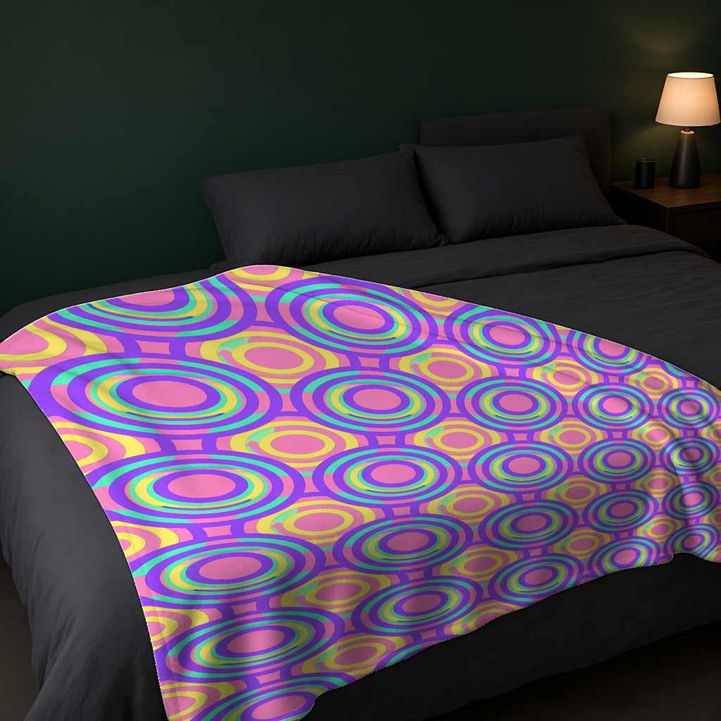 Interlocking Ring Ripples Sherpa Fleece Blanket across the foot of a dark bed