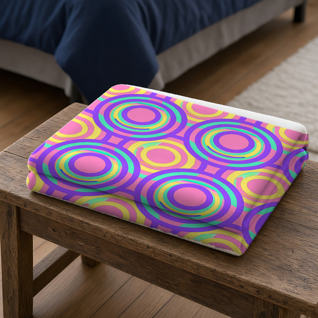 Interlocking Ring Ripples Sherpa Fleece Blanket folded on a wooden bench