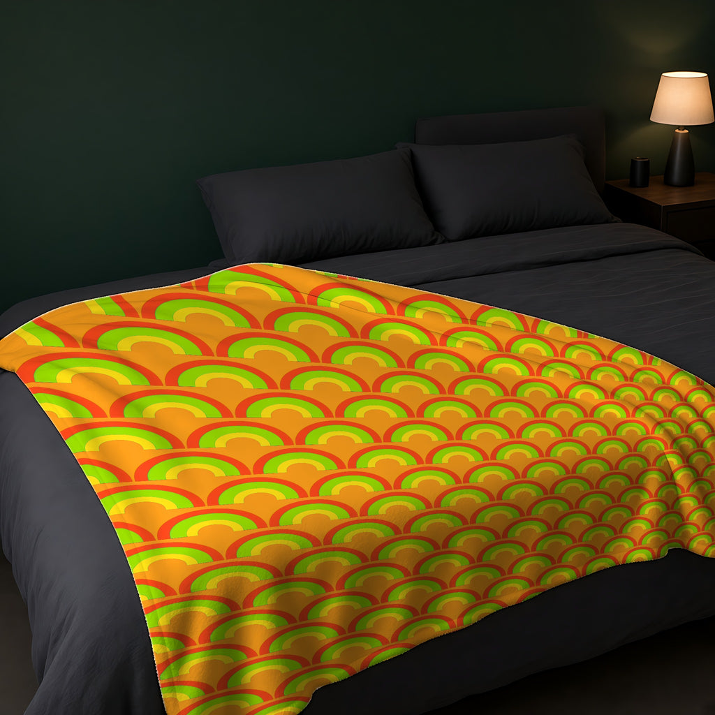 Chromatic Scallop Ripple Sherpa Fleece Blanket across the foot of a dark bed