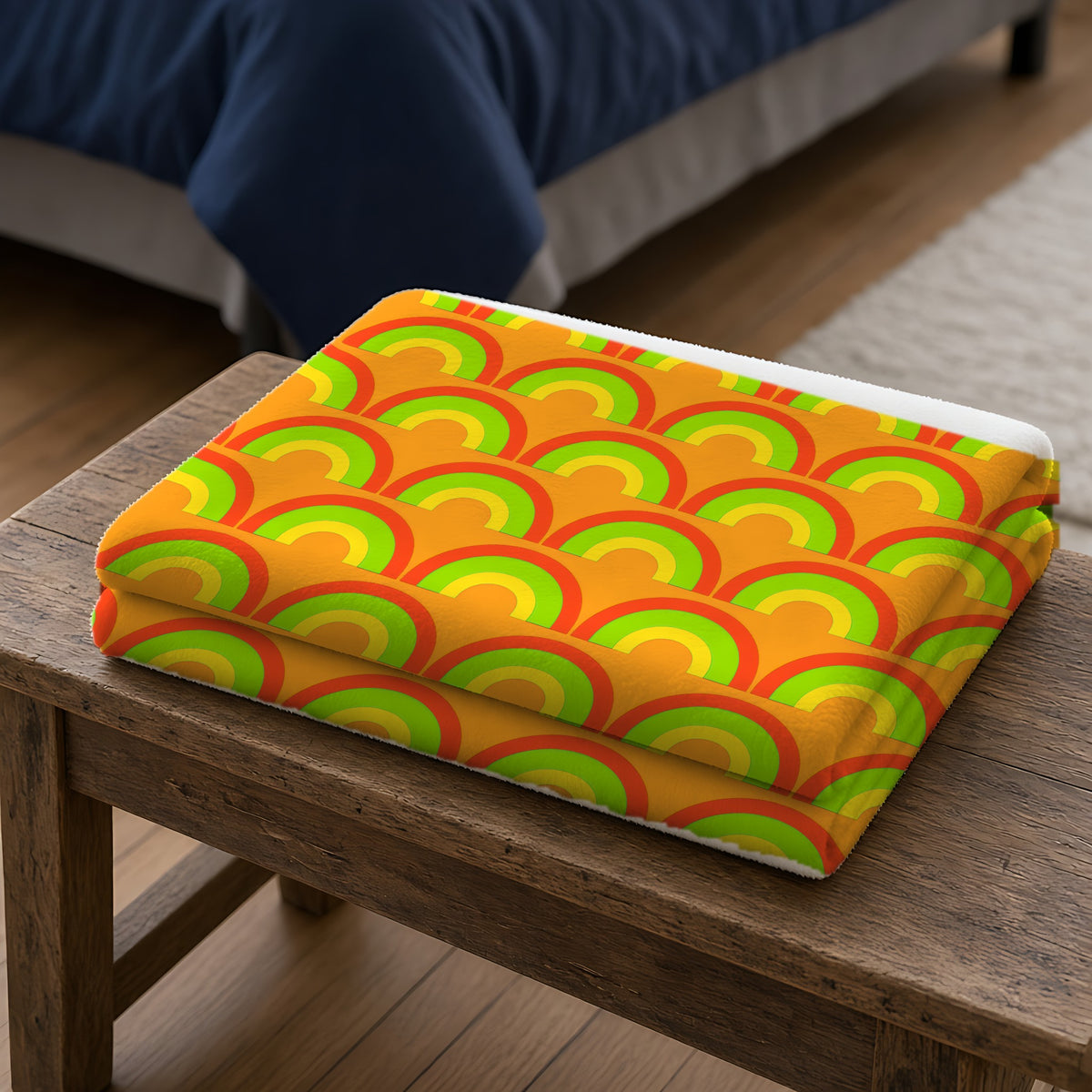 Chromatic Scallop Ripple Sherpa Fleece Blanket folded on a wooden bench