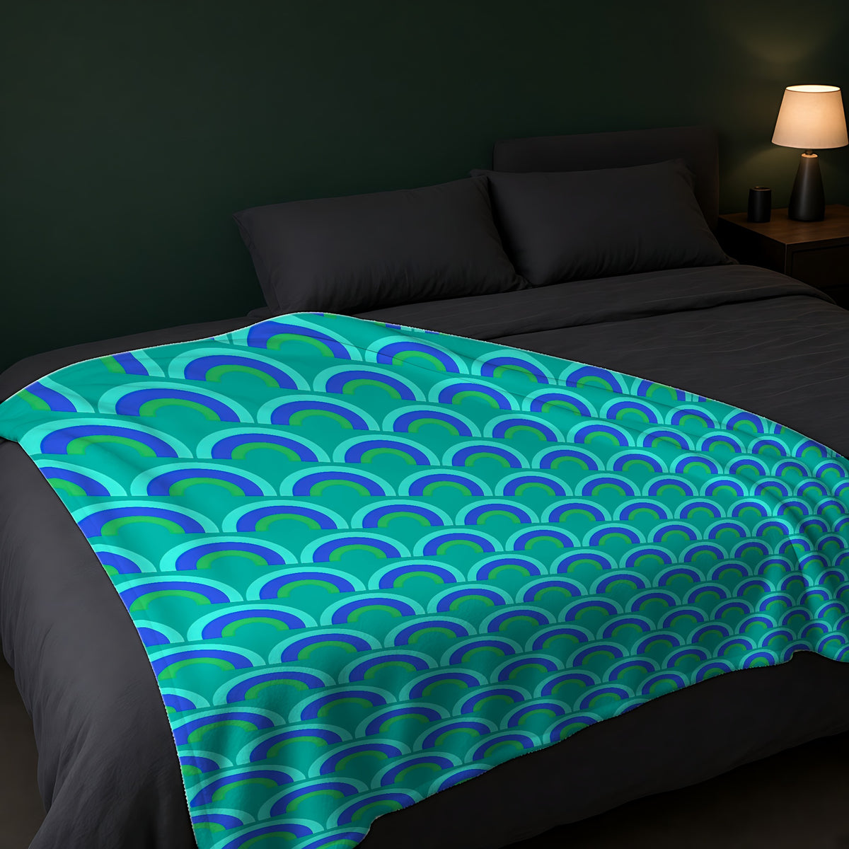 Chromatic Scallop Ripple Sherpa Fleece Blanket across the foot of a dark bed