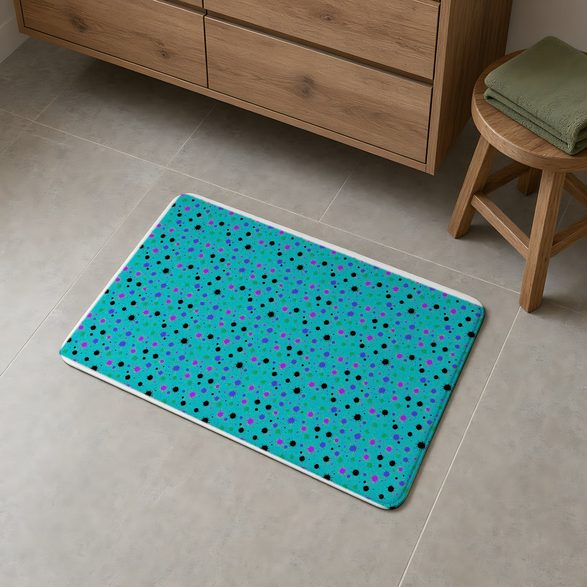 Splat Storm Bath Mat on a grey tiled bathroom floor
