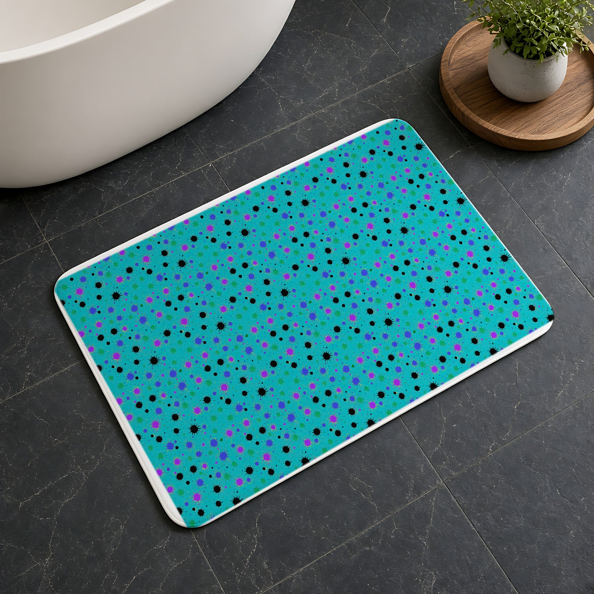 Splat Storm Bath Mat on a dark slate floor beside a bath