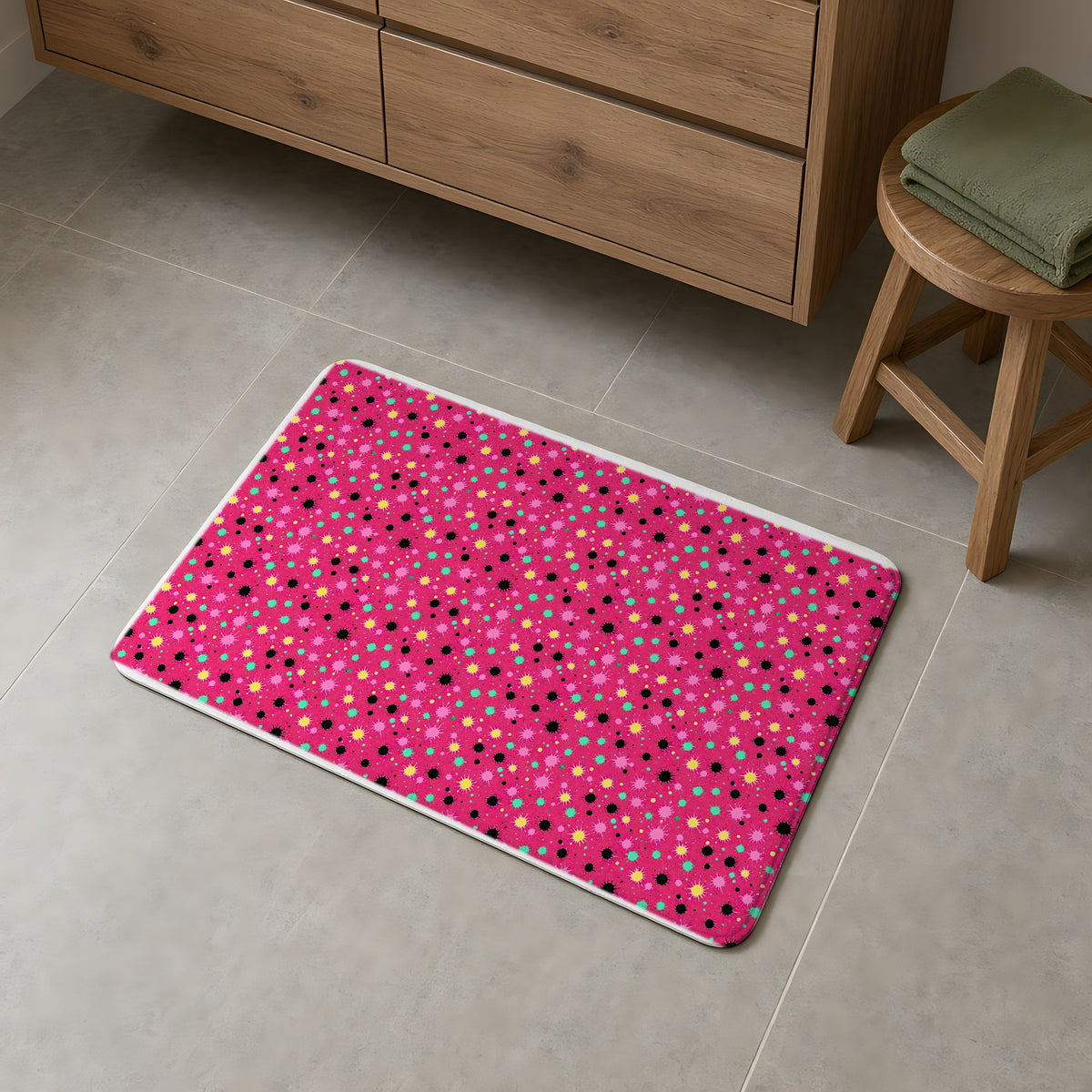 Splat Storm Bath Mat on a grey tiled bathroom floor