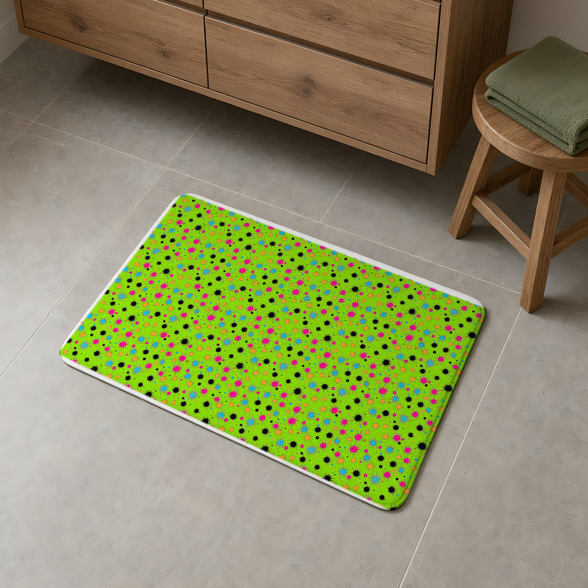 Splat Storm Bath Mat on a grey tiled bathroom floor