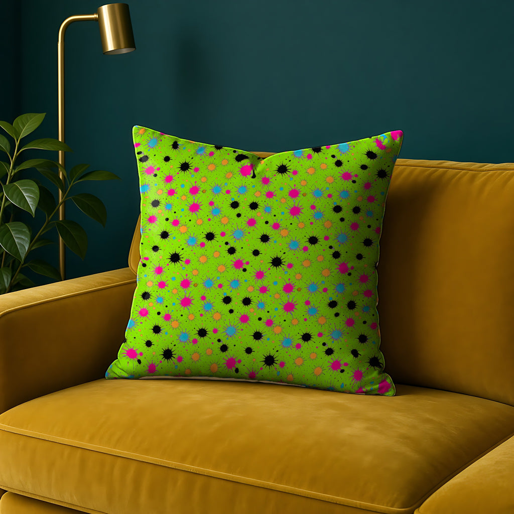 Splat Storm Faux Suede Cushion in the Tropical Punch palette, on a mustard sofa against a teal wall