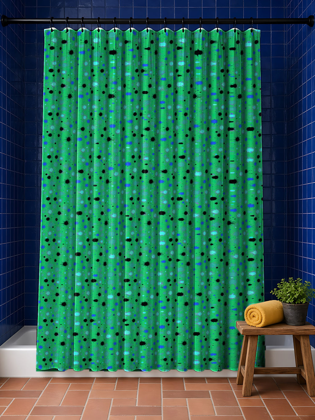 Splat Storm Shower Curtain in the Ocean Jewel palette, hanging in a bathroom with cobalt tiles and a terracotta floor