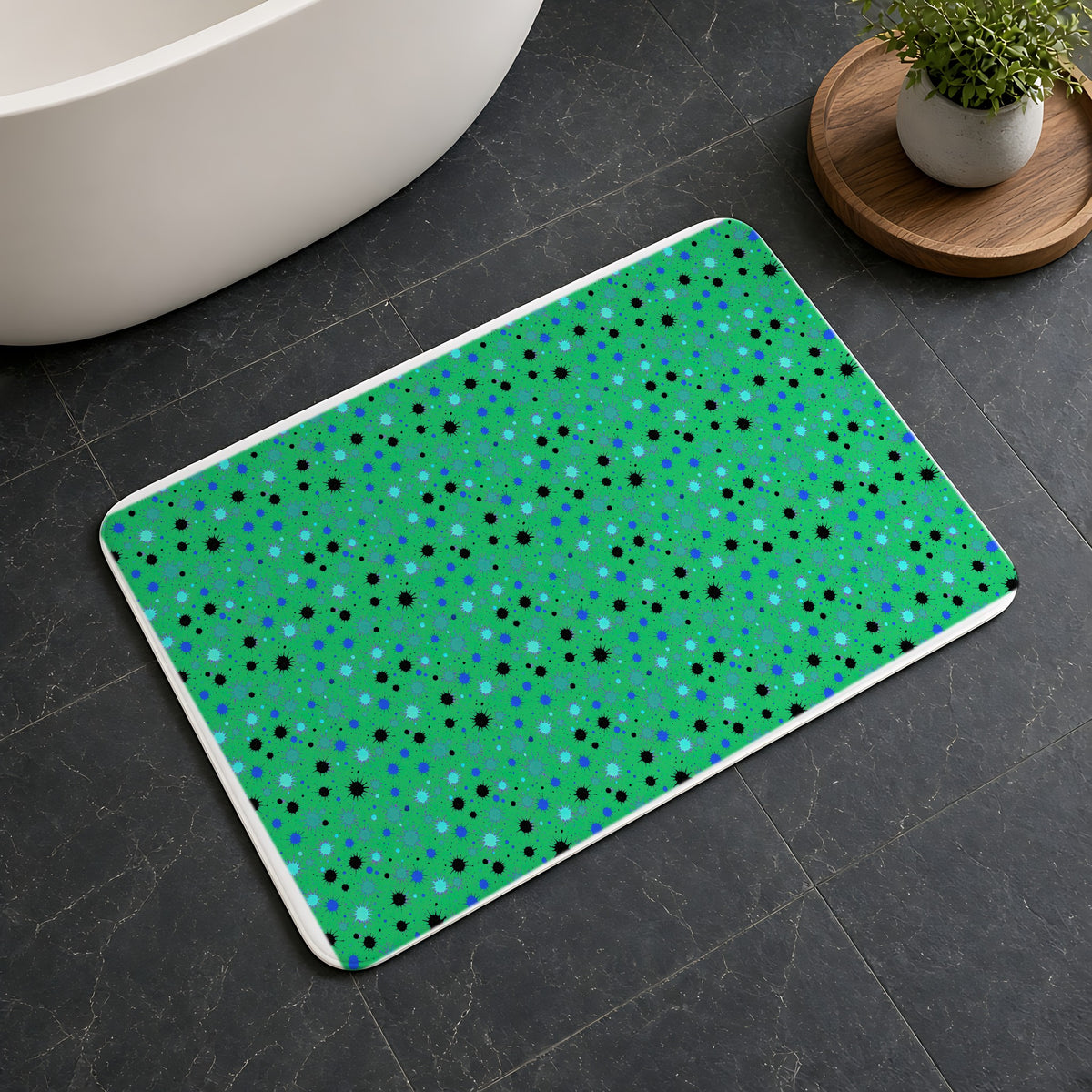 Splat Storm Bath Mat on a dark slate floor beside a bath