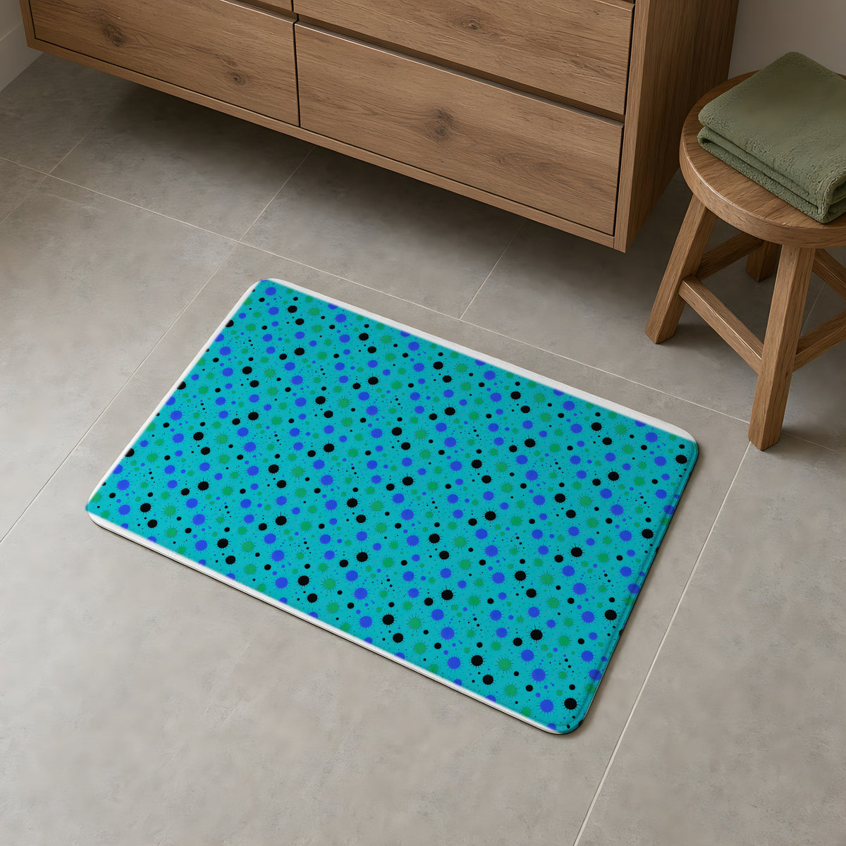 Blot Burst Bath Mat on a grey tiled bathroom floor