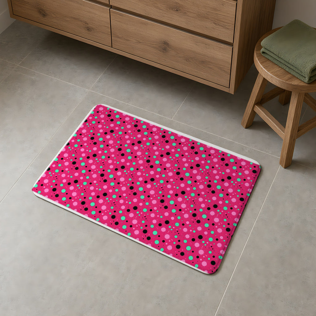 Blot Burst Bath Mat on a grey tiled bathroom floor