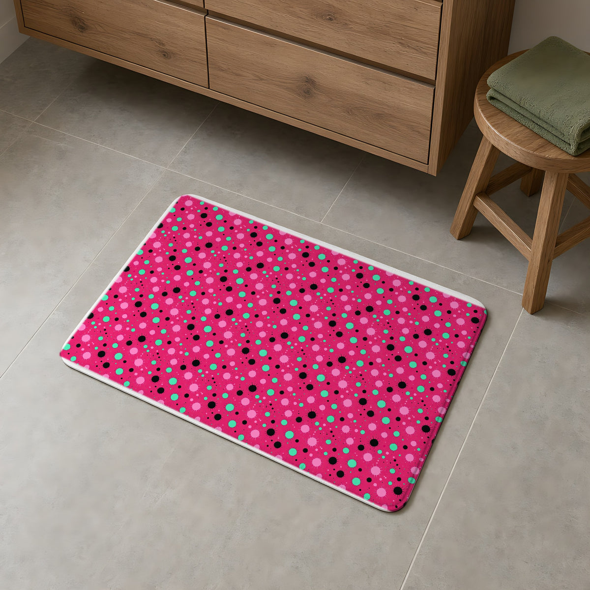 Blot Burst Bath Mat on a grey tiled bathroom floor