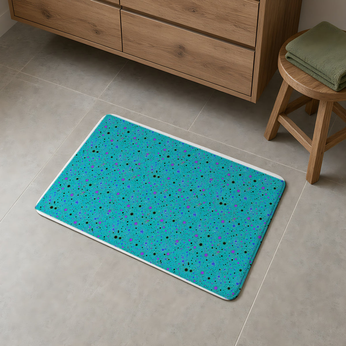 Spray Field Bath Mat on a grey tiled bathroom floor