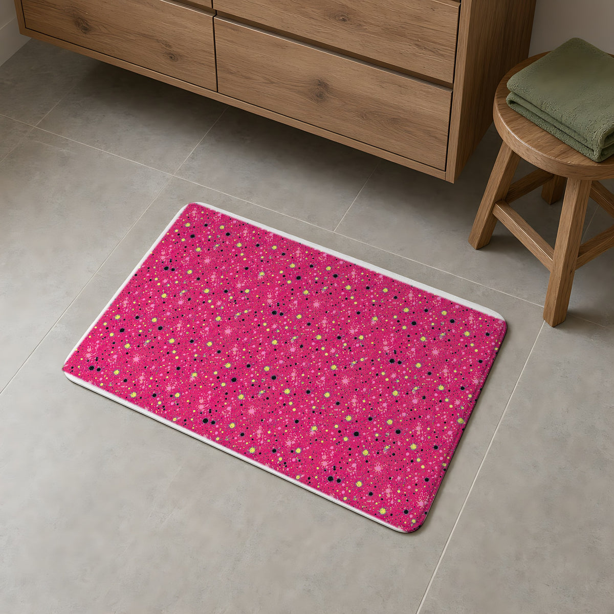 Pink Spray Field Bath Mat on a grey tiled bathroom floor