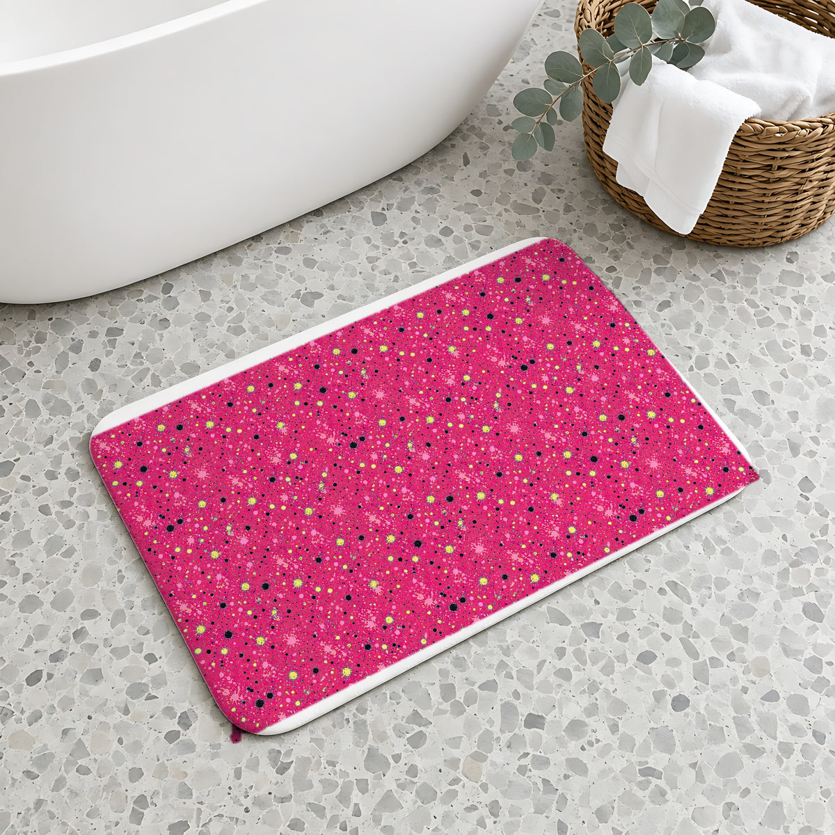 Pink Spray Field Bath Mat on a terrazzo floor beside a freestanding bath