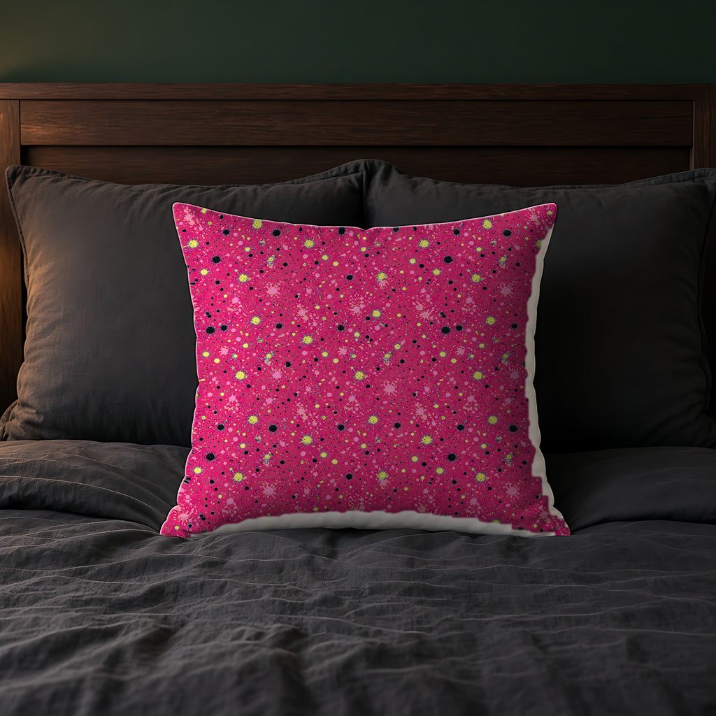 Pink Spray Field Faux Suede Cushion on a bed with charcoal bedding