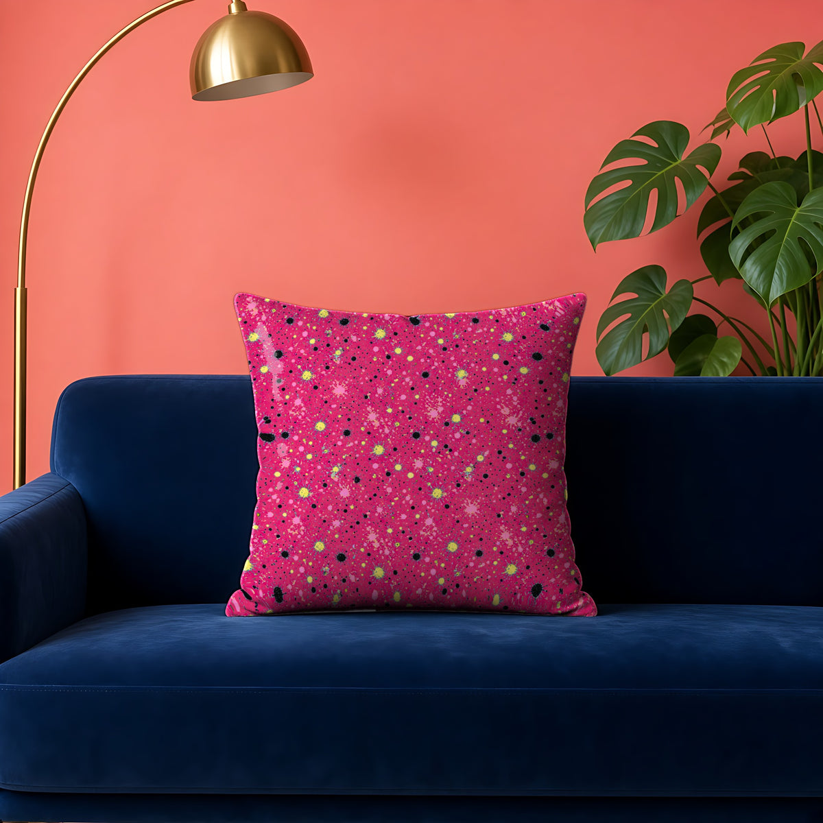 Pink Spray Field Faux Suede Cushion in the Candy Pop on Raspberry palette, on a navy velvet sofa against a coral wall