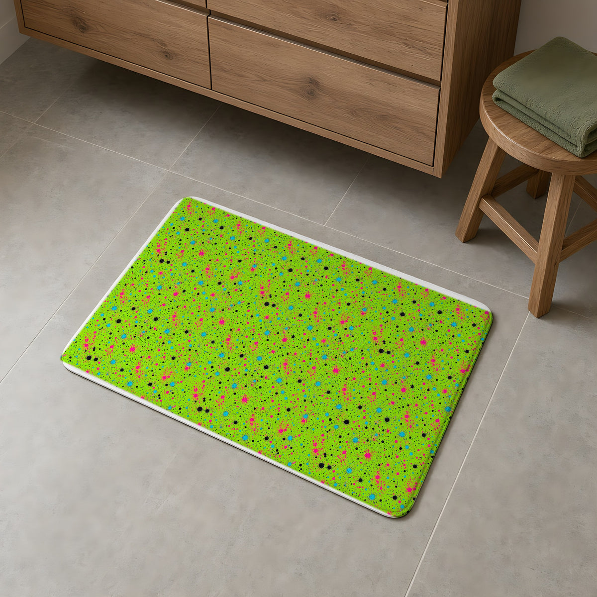 Pink Spray Field Bath Mat on a grey tiled bathroom floor