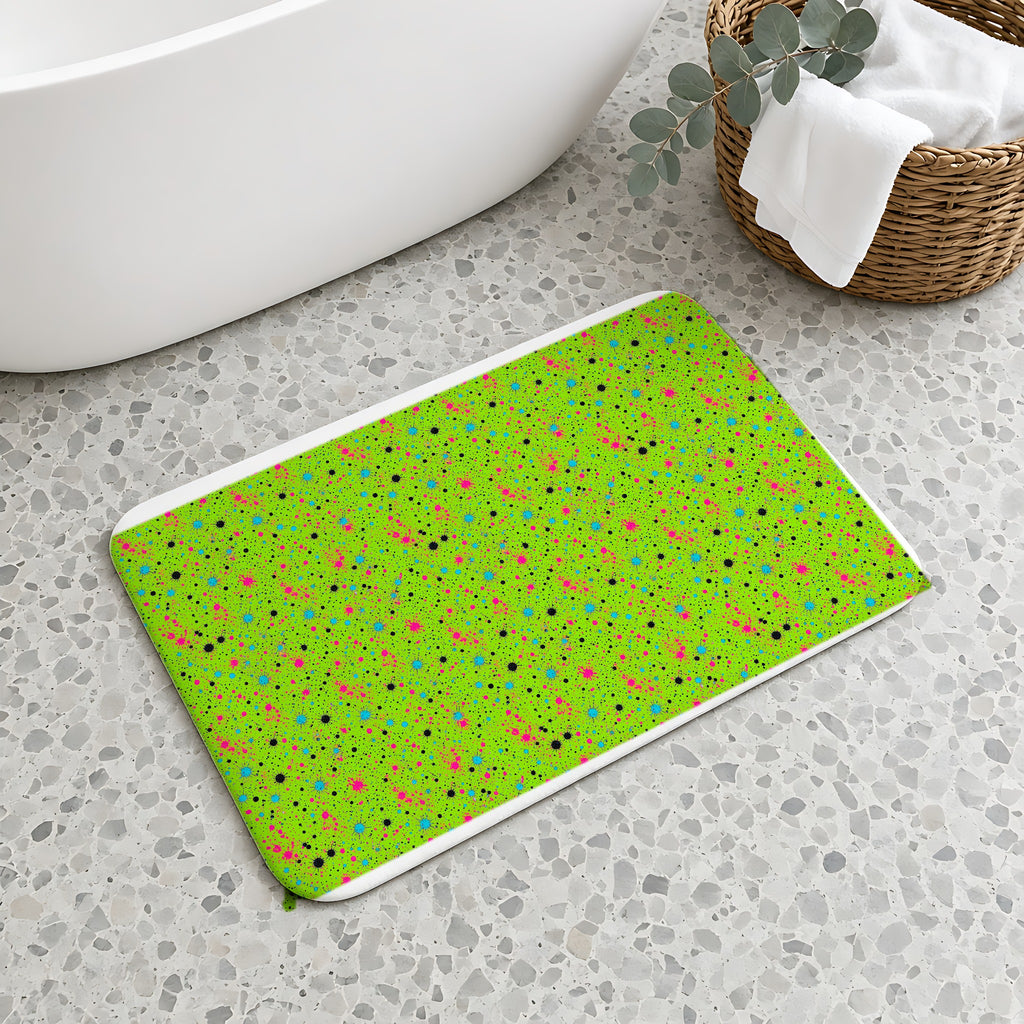 Pink Spray Field Bath Mat on a terrazzo floor beside a freestanding bath