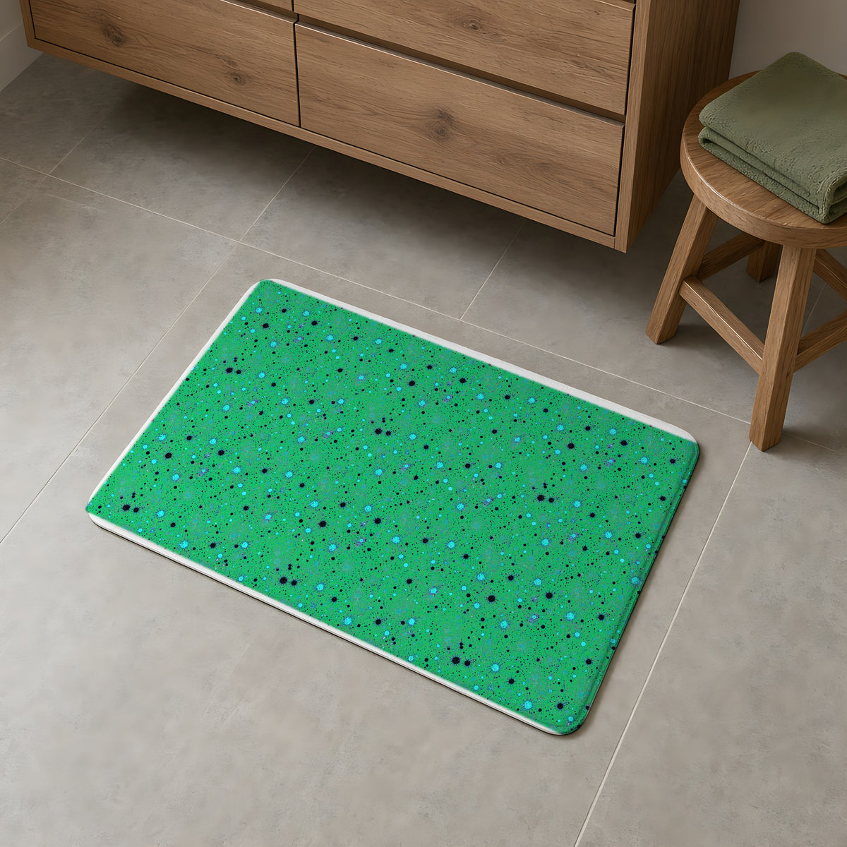 Spray Field Bath Mat on a grey tiled bathroom floor