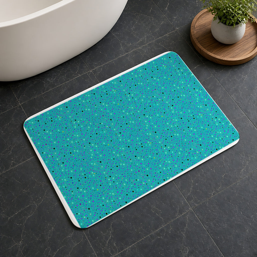 Confetti Spatter Bath Mat on a dark slate floor beside a bath