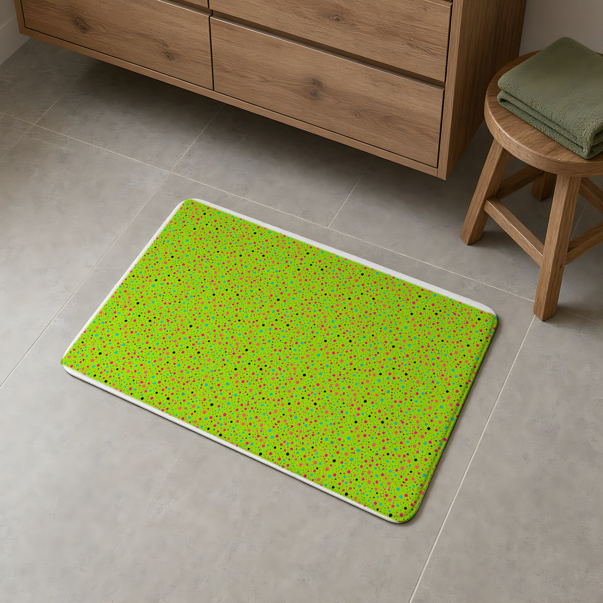 Confetti Spatter Bath Mat on a grey tiled bathroom floor