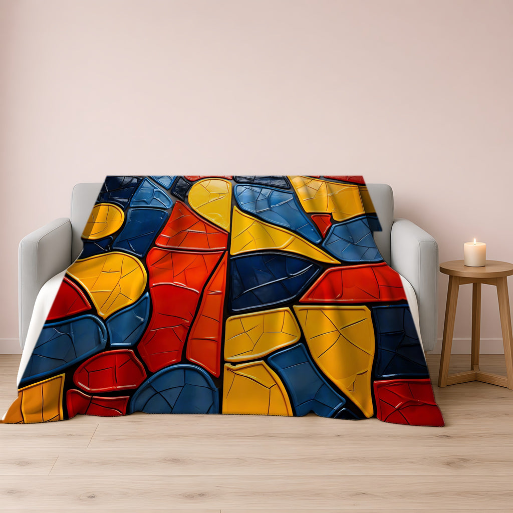 Bold Mosaic Glass Sherpa Fleece Blanket draped over a grey sofa