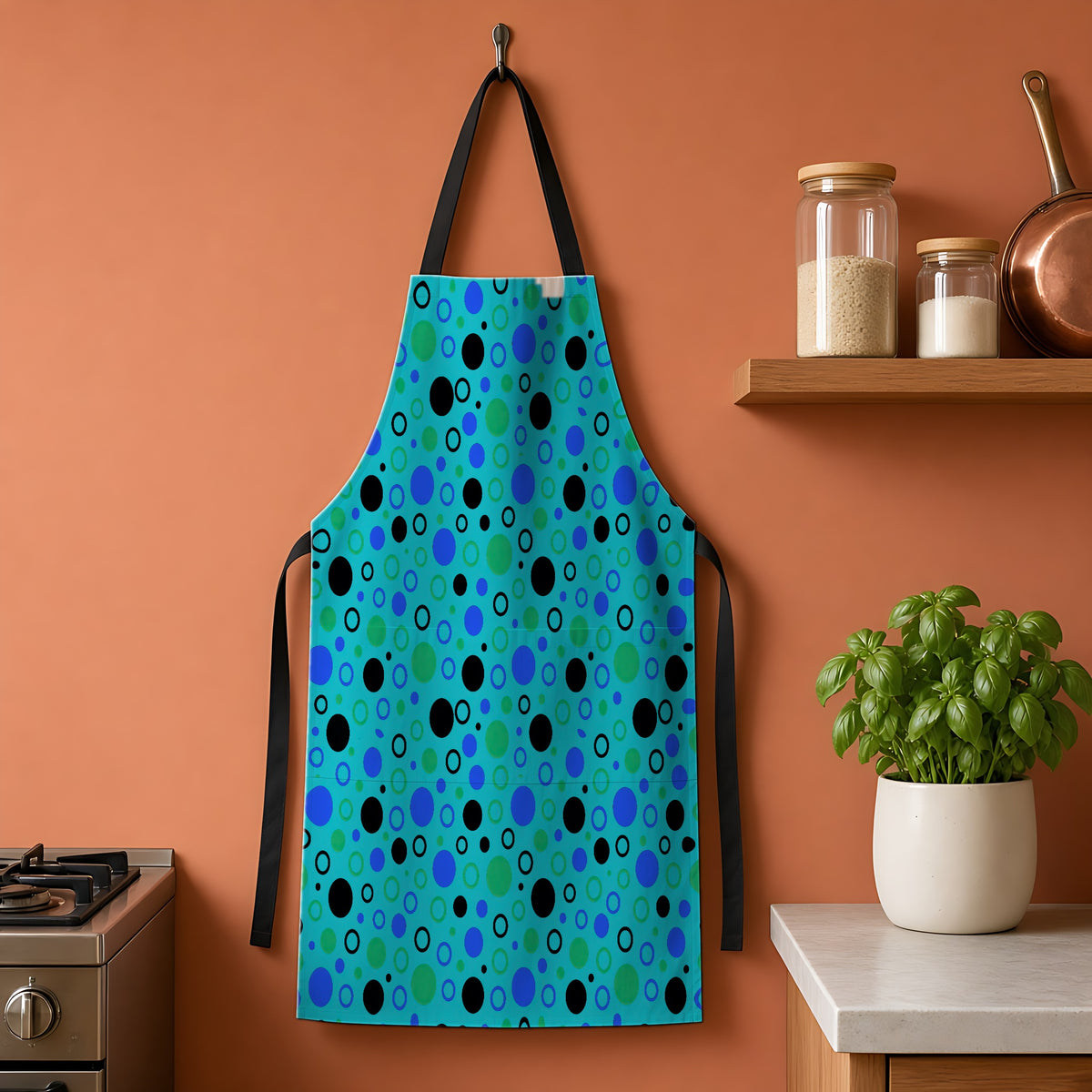 Bubble Outlines Apron hanging on a terracotta kitchen wall