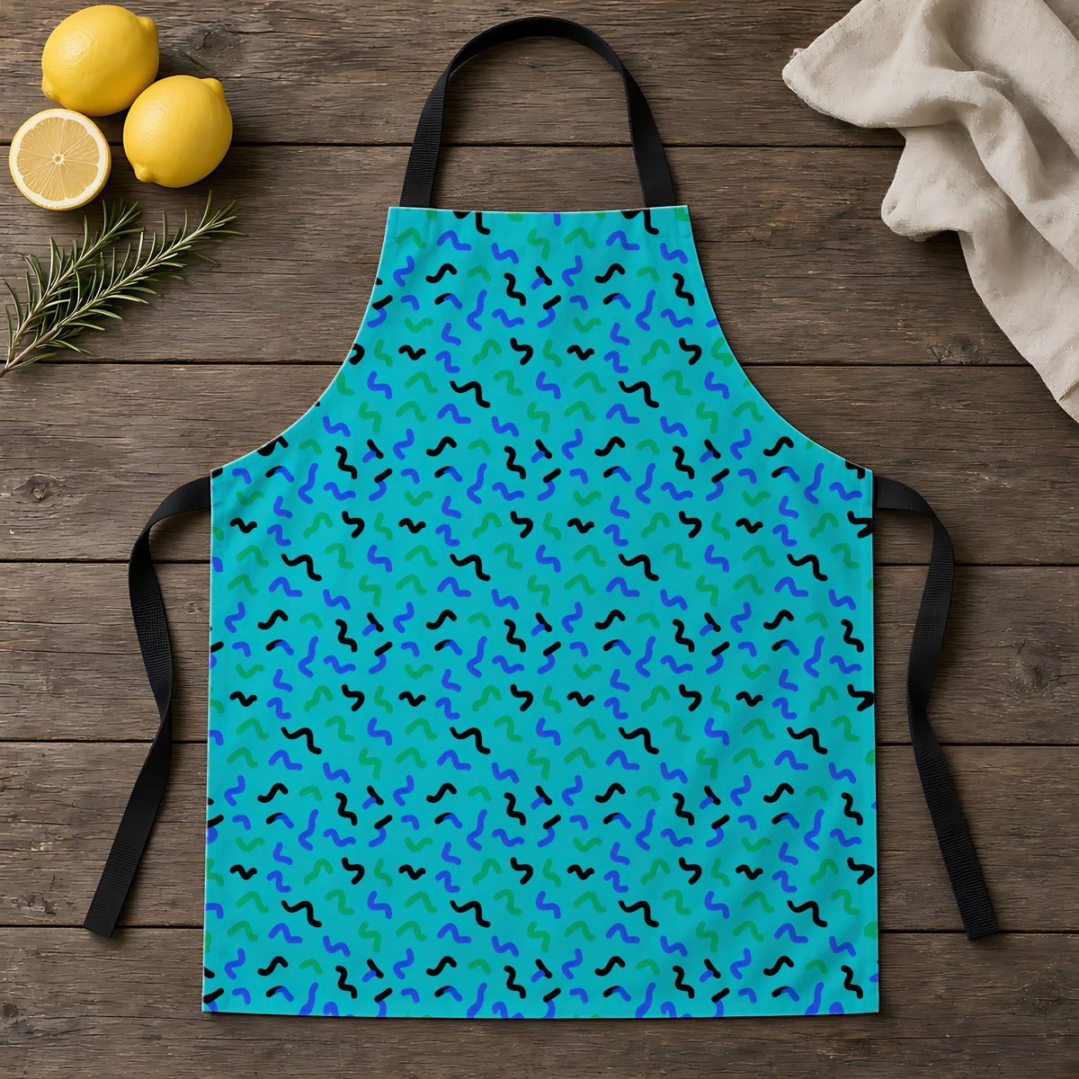 Squiggle Strokes Apron laid flat on a rustic wooden table