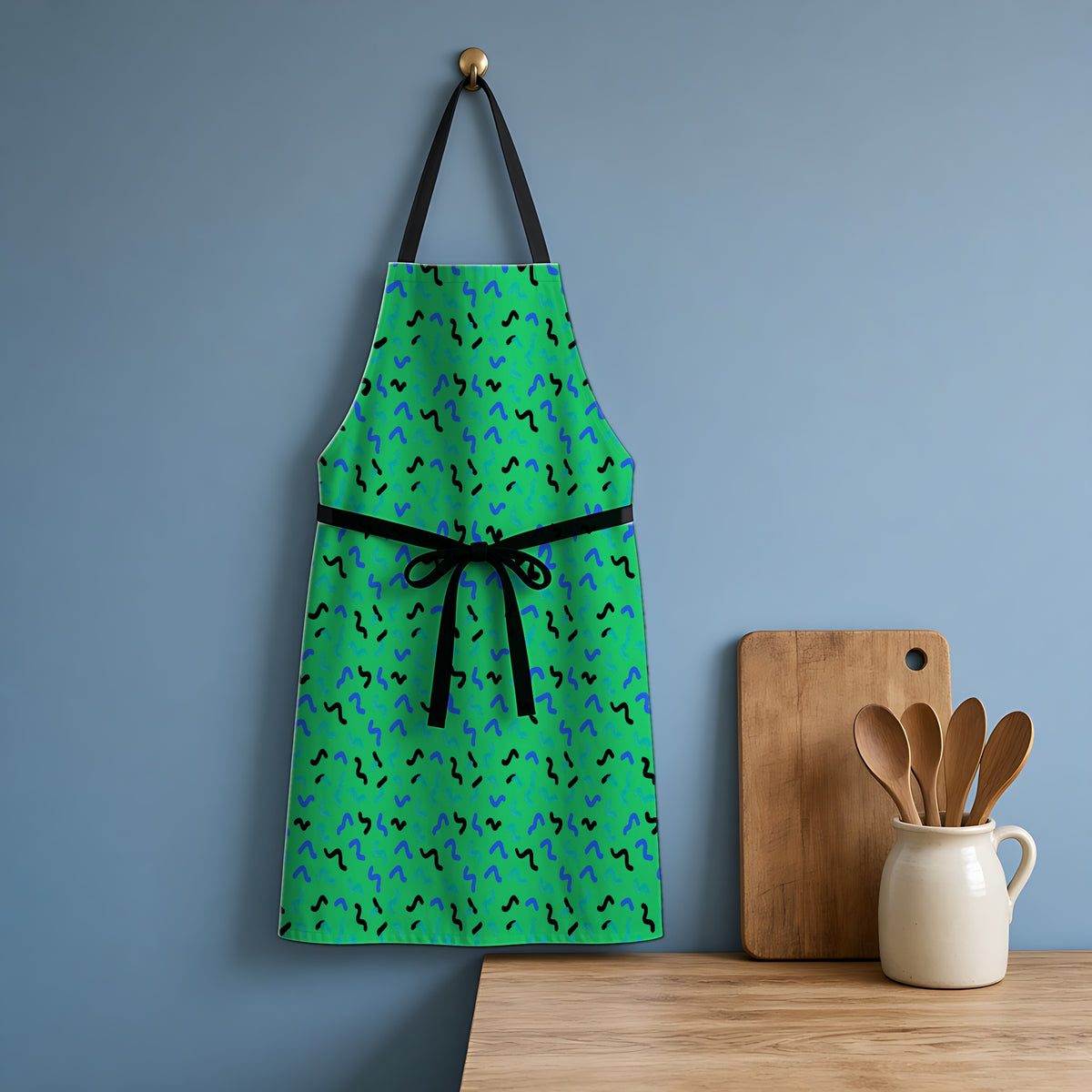 Squiggle Strokes Apron hanging in a blue kitchen