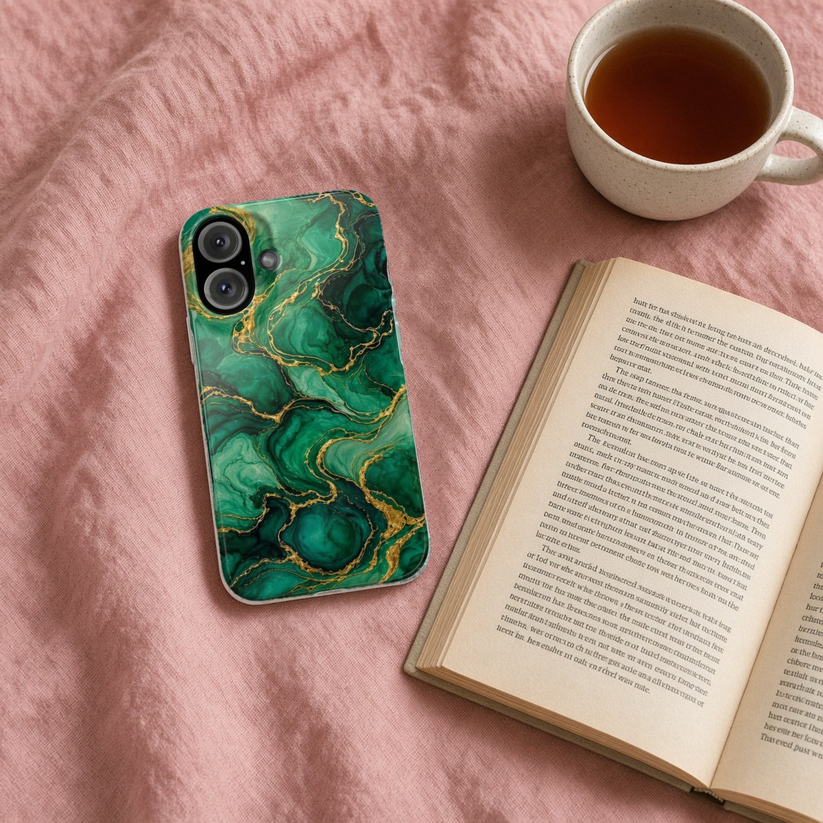 Emerald Tide-Pool Pour slim phone case on a pink bedspread with a book and tea