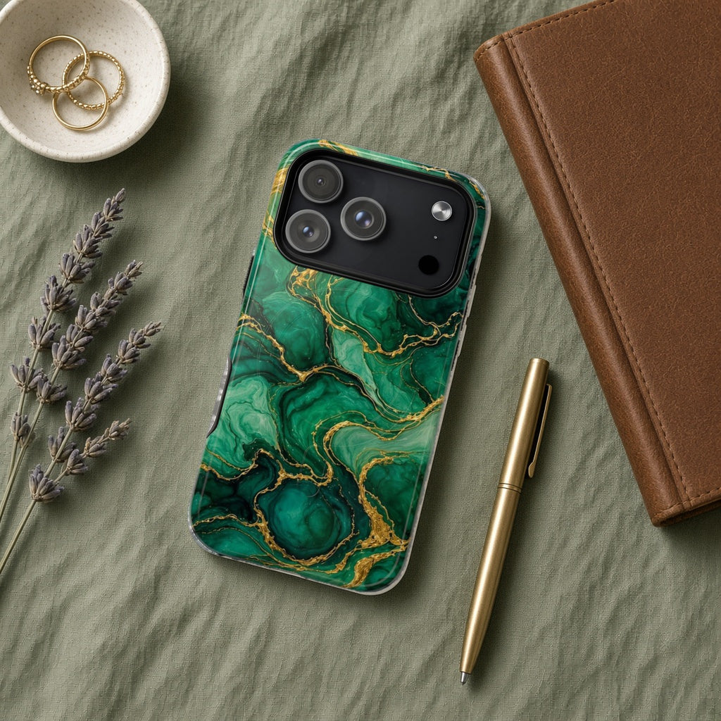 Emerald Tide-Pool Pour magnetic iPhone case flat lay on sage linen with a notebook and pen