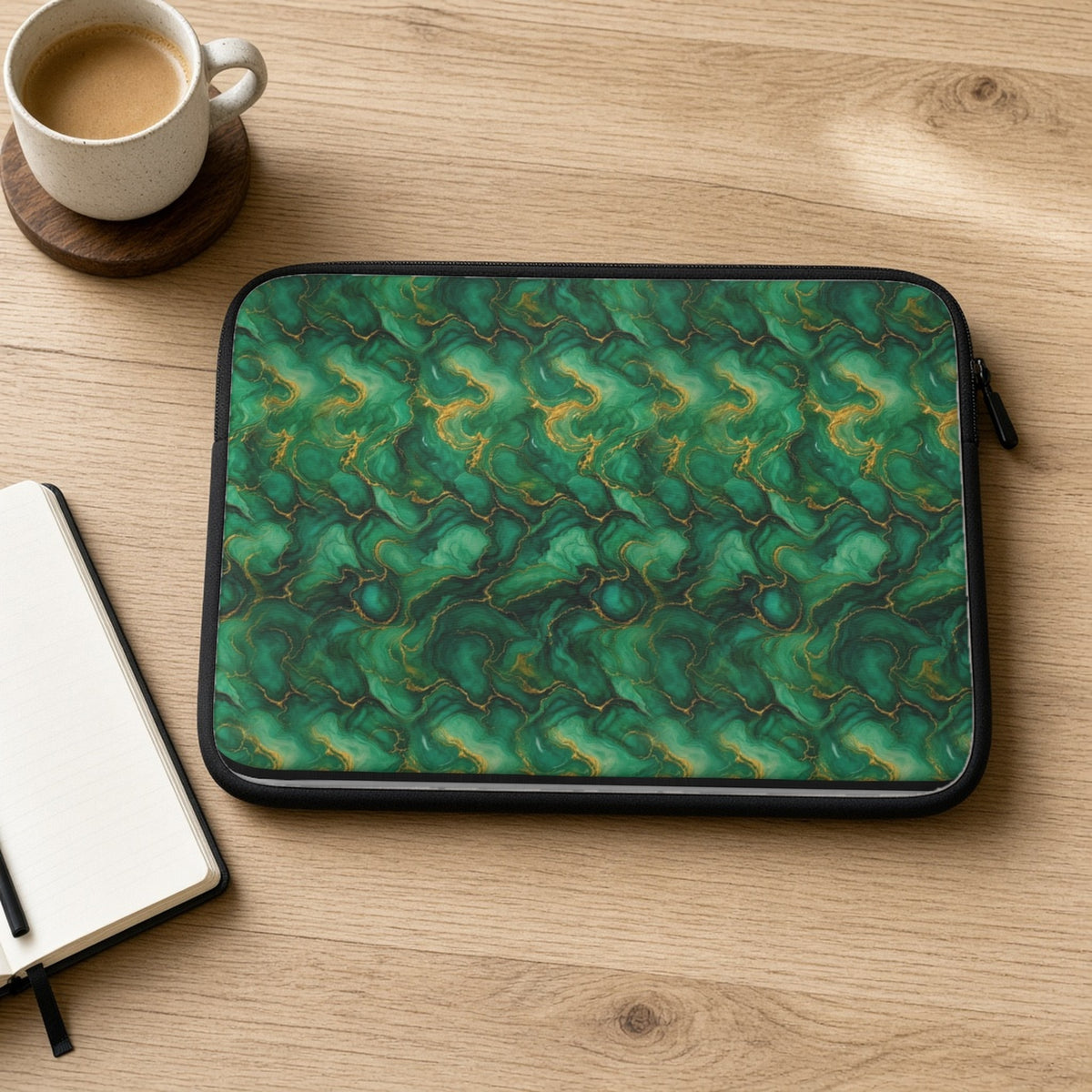 Emerald Tide-Pool Pour laptop sleeve on an oak desk with coffee and a notebook