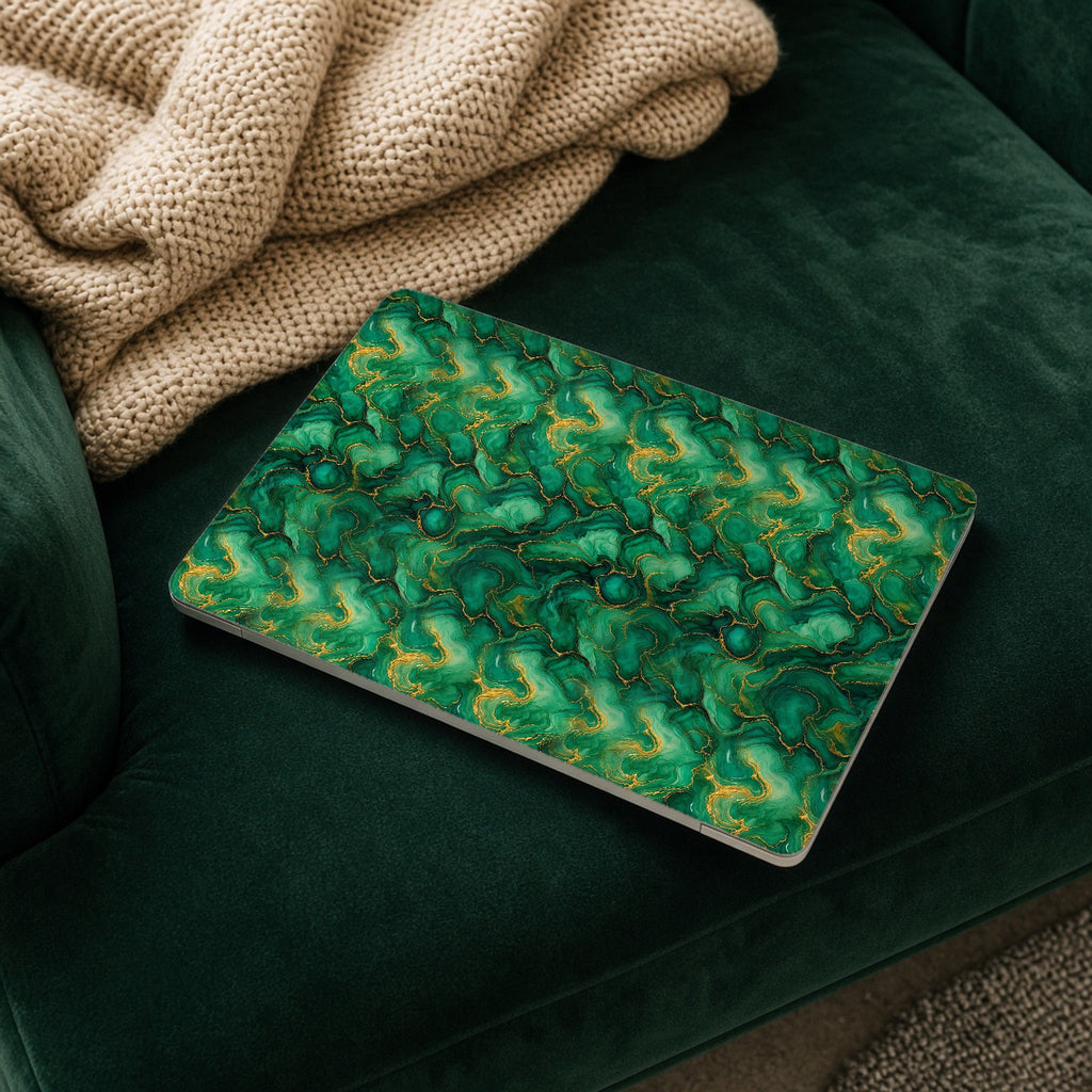 Emerald Tide-Pool Pour matte MacBook case on a laptop resting on a green velvet sofa
