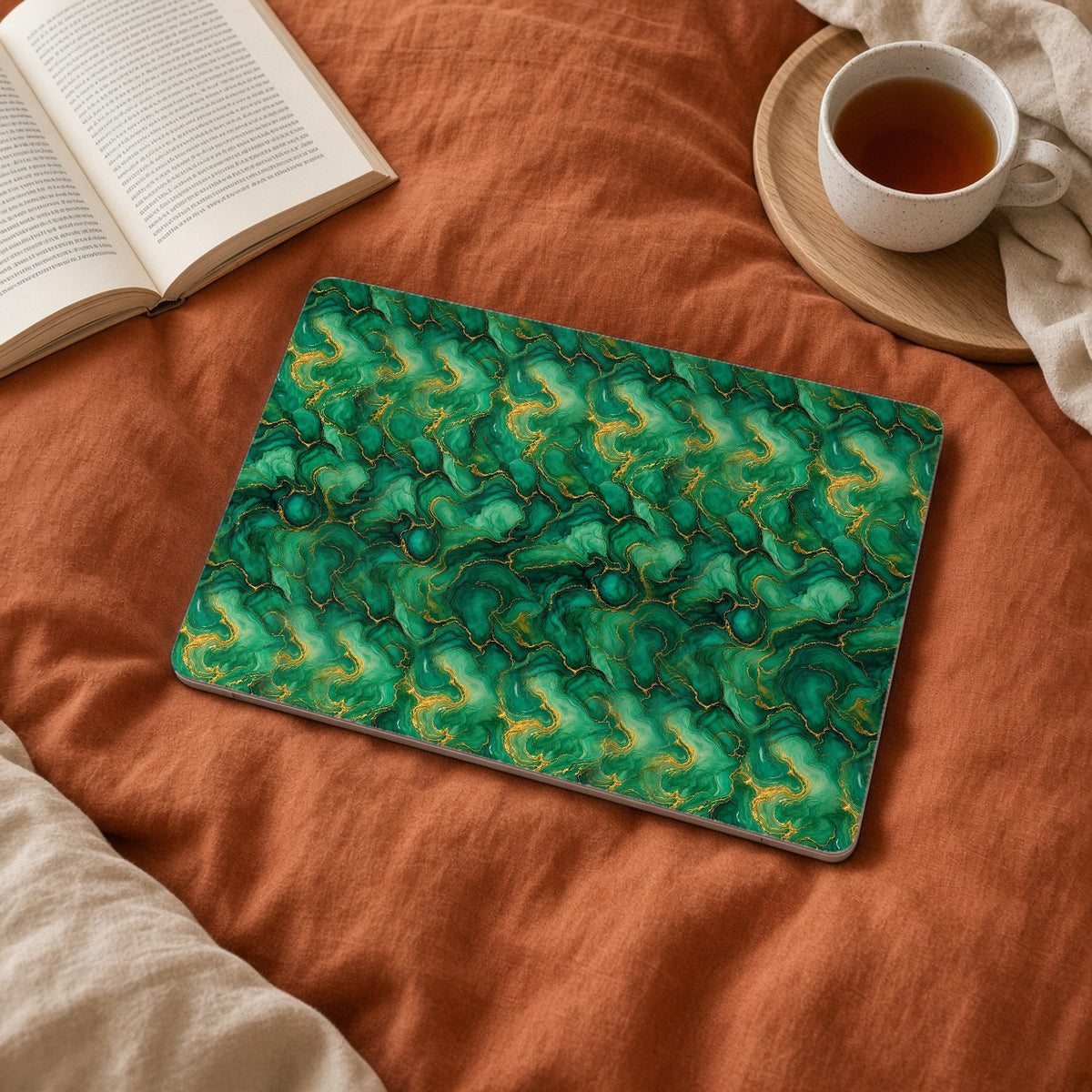 Emerald Tide-Pool Pour matte MacBook case on a laptop on rust linen bedding