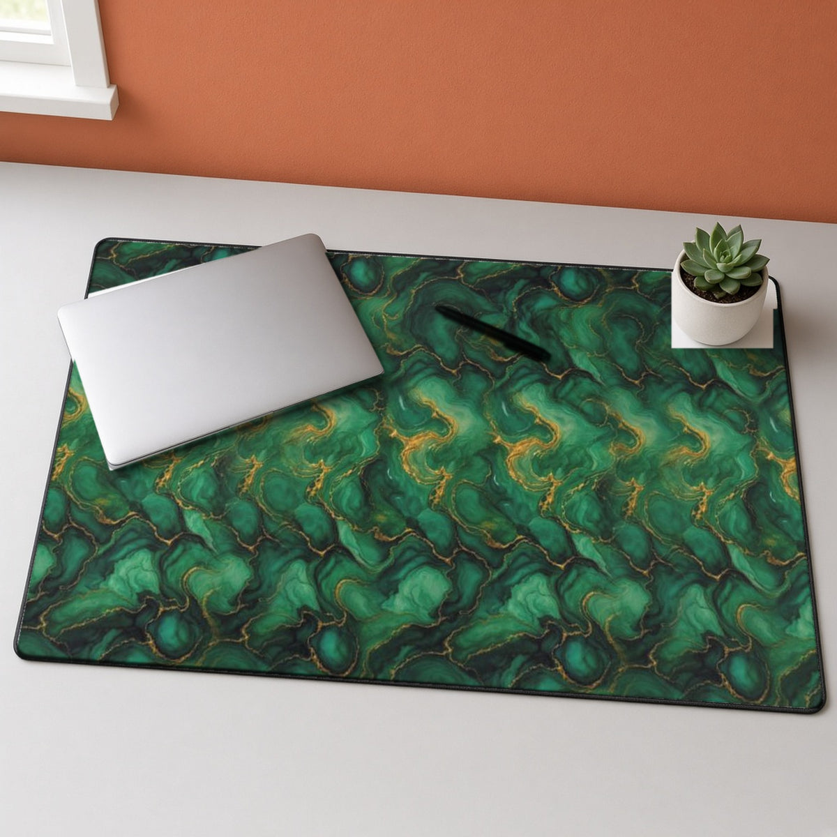 Emerald Tide-Pool Pour desk mat on a grey desk with a laptop and a plant