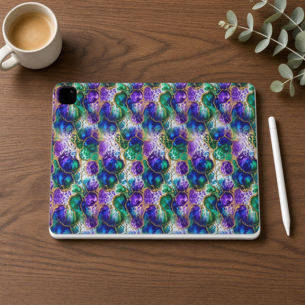 Peacock Acrylic Pour Cells iPad folio case on a walnut desk with a stylus and coffee
