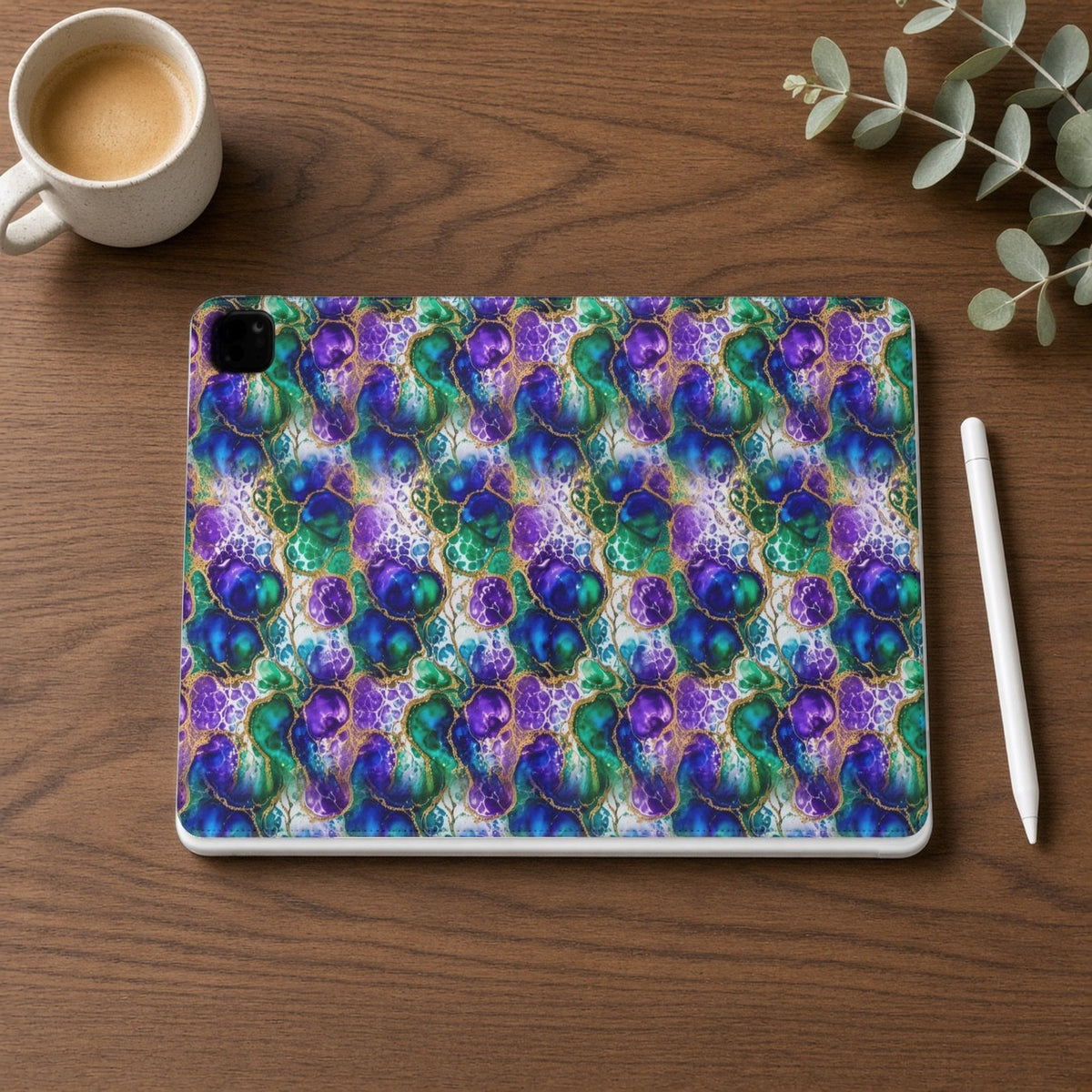 Peacock Acrylic Pour Cells iPad folio case on a walnut desk with a stylus and coffee