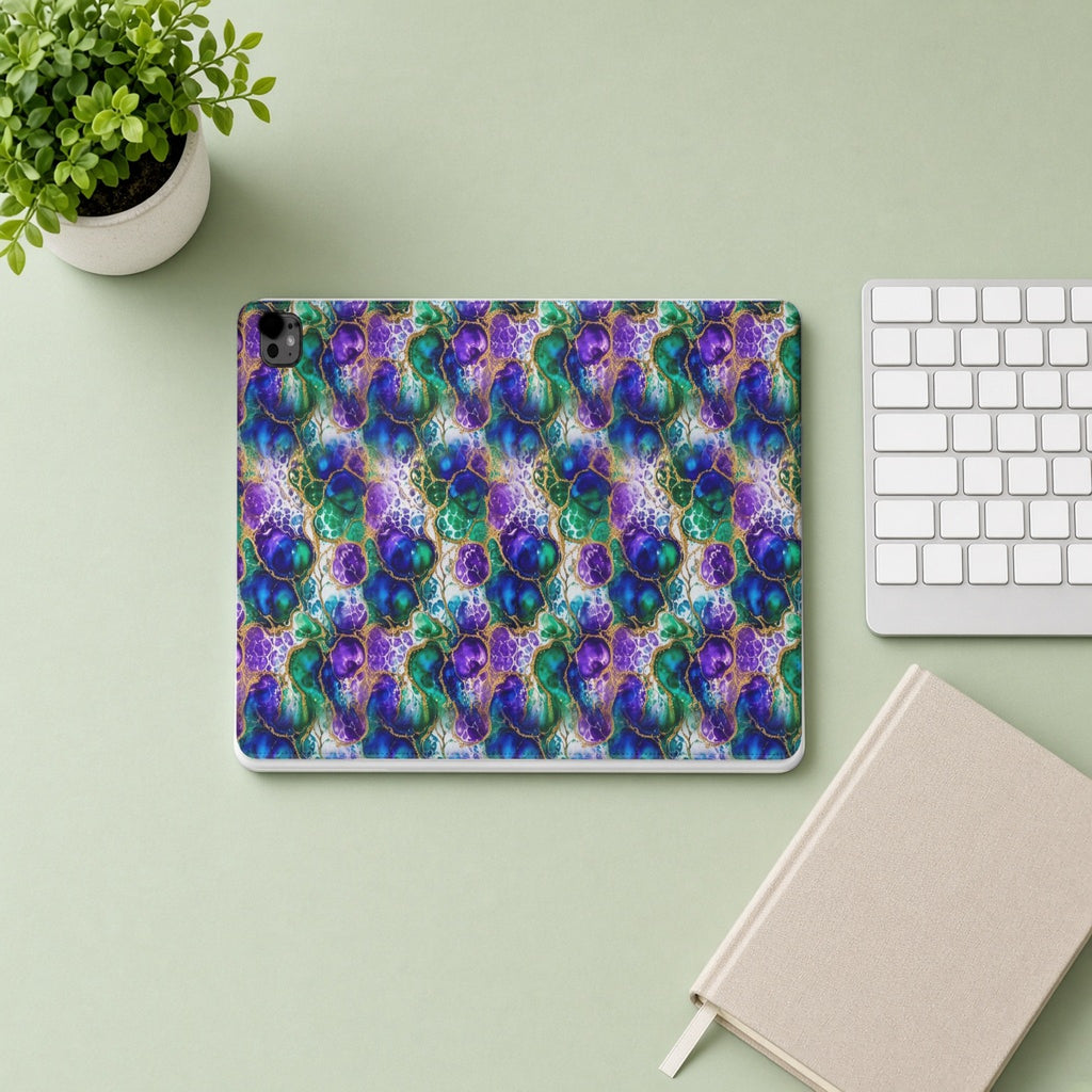 Peacock Acrylic Pour Cells iPad folio case from above on a sage desk with a keyboard and notebook
